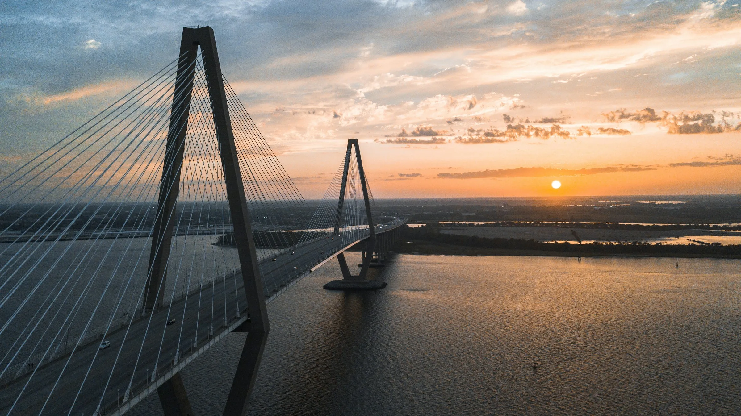 The Arthur Ravenel Jr. Bridge over Charleston Harbor at sunset